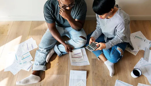 couple paying bills on the floor