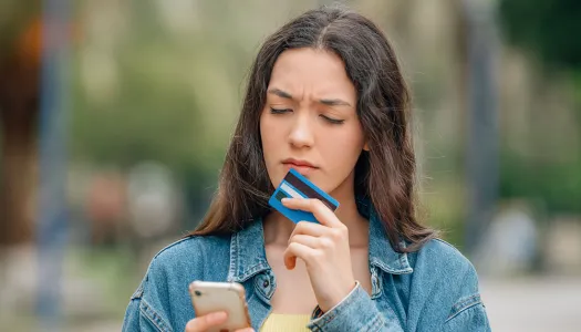 woman pondering with credit card