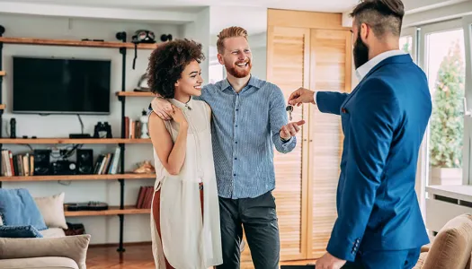 young couple getting keys to home