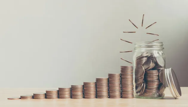 coins leading to a jar of savings