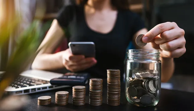 woman collecting coins for savings