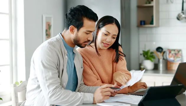 couple assessing finances on computer