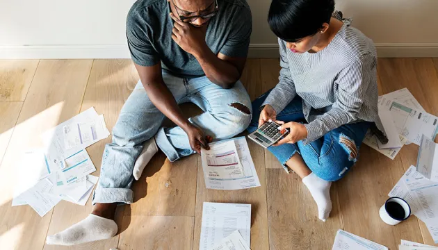 couple on the floor with bills